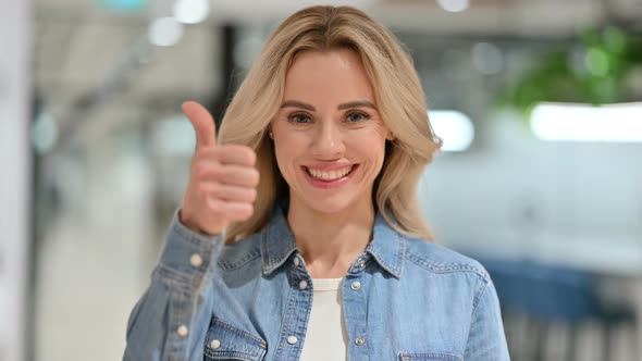 Positive Young Casual Woman with Thumbs Up Sign 