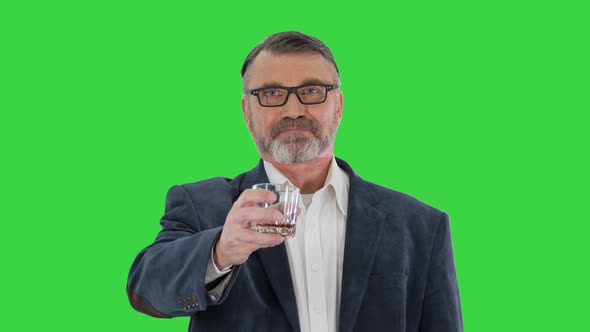 Old Man in Glasses Drinking Whiskey Cheers on a Green Screen Chroma Key