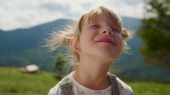 Portrait Girl Enjoying Sunlight in Mountains