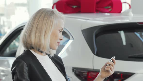 Charming Woman Smiling To the Camera, Holding Car Keys