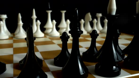 Chess on a chessboard. Shooting on a black background.