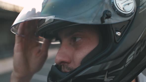 Portrait of Young Attractive Motorcyclist in Black Helmet on Street