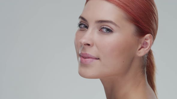 Studio portrait of young, beautiful and natural redhead woman. Beauty concept.