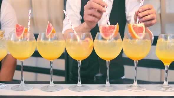 Bartenders Prepare Nonalcoholic Orange Cocktails with Grapefruit