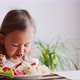 A little child girl is eating spaghetti at home - VideoHive Item for Sale