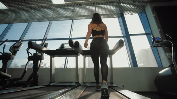 Fitness Woman Walking on Treadmill in Gym Having Cardio Training
