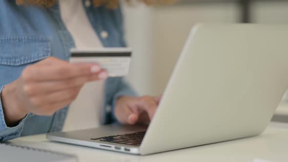 Close Up of Hand of African Woman Making Online Shopping Payment on Laptop with Credit Card