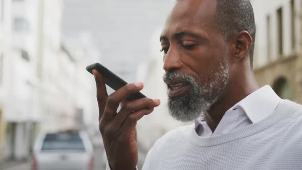 African American man using his phone in the street