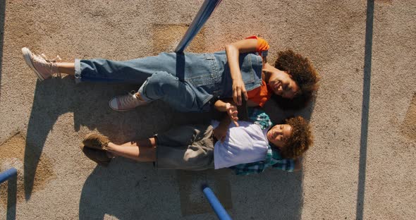 Mother and son using phone at playground