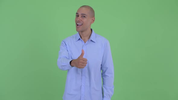 Happy Bald Multi Ethnic Businessman Giving Thumbs Up