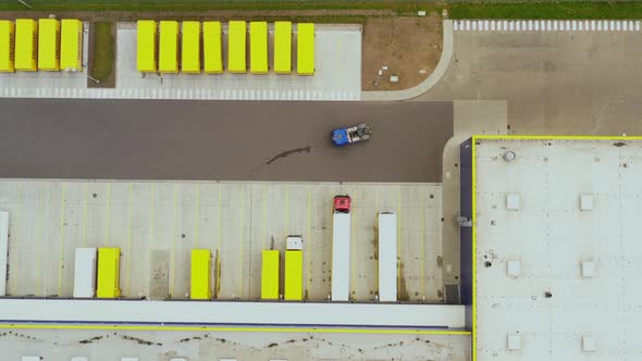 Aerial view. goods distribution warehouse. Semi trucks loading cargo containers. Logistics export an