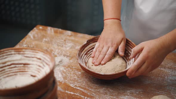 Man kneading dough with his hands to make bread