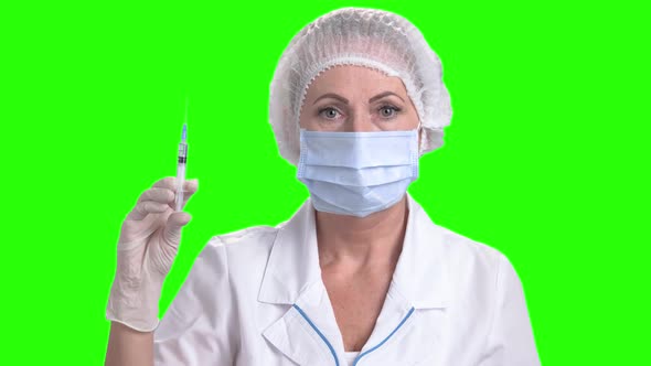 Doctor Woman Holding Syringe on Green Screen.