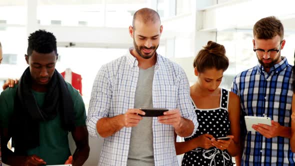 Group of colleagues using electronic devices