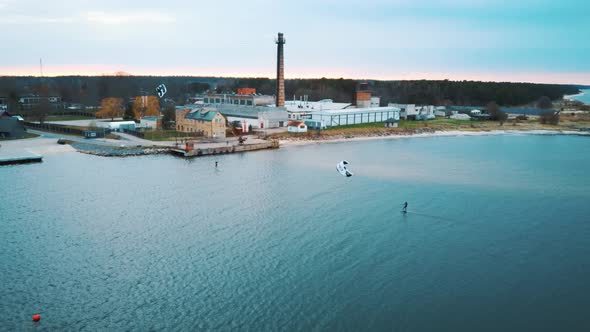 Aerial Drone View of a Corekites Kitesurfers Hydrofoiling  in Engure Port at in Baltic Sea