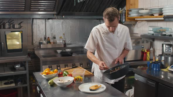 Chef Serving Asian-Style Vegetables On Plate