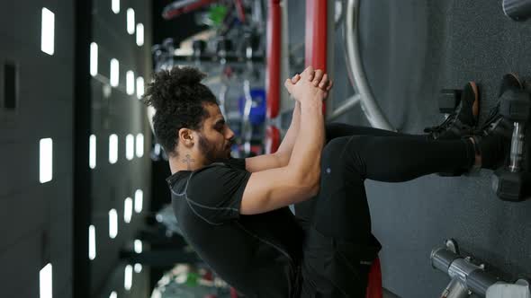 The Man Sitting and Breathing After Finish Weight Training Course at Gym