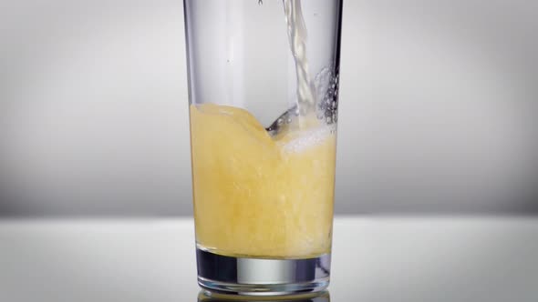 Slow motion shot of beer being poured into a glass