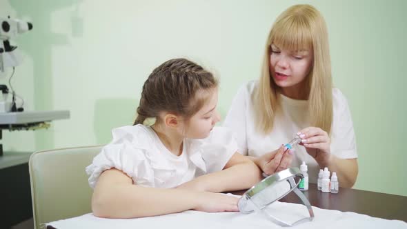 Doctor Shows and Explains to Girl How to Use Night Orthokeratological Lenses