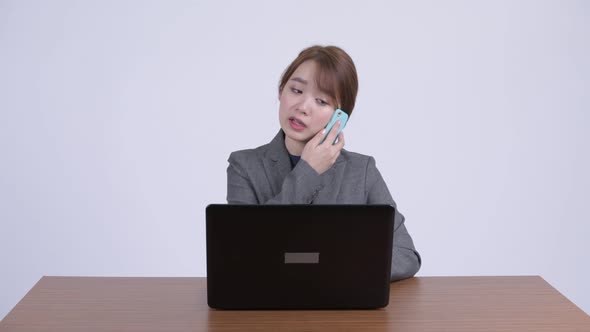 Young Stressed Asian Businesswoman Multitasking and Getting Frustrated