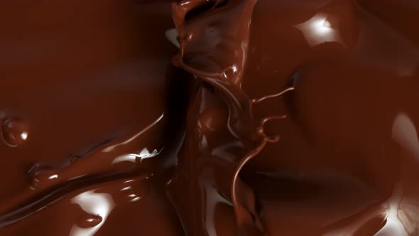 Super Slow Motion Shot of Splashing Melted Chocolate Background at 1000Fps.
