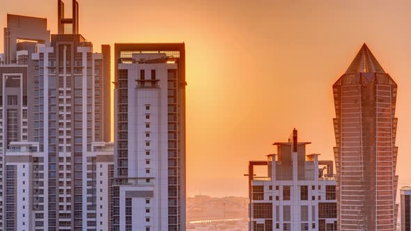 Sunset Behind Modern Residential and Office Complex Aerial Timelapse at Business Bay Dubai