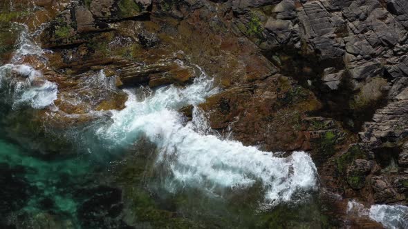 Top View on the Splashing Sea Waves on the rocky beach in Norway