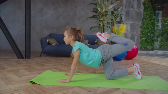 Sporty Fit Preadolescent Girl Performing Donkey Kick Exercise