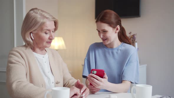 A Woman Turns on Different Music for Her Elderly Mother