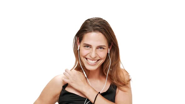 Young Beautiful Girl Dancing Singing Listening Music in Headphones Over White Background