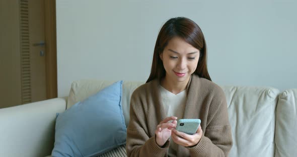 Asian woman use of smart phone at home