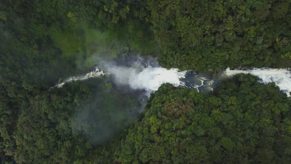 Beautiful Waterfall Among Lush Dense Greenery