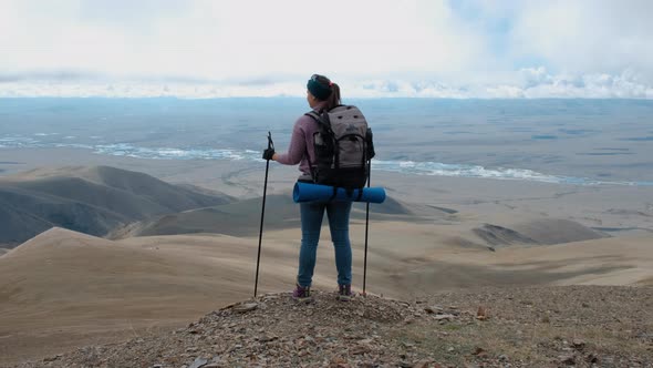 Young Woman Traveler Open Arms at Mountain Peak