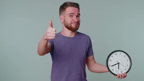 Bearded Young Man Showing Time on Clock Watch Ok Thumb Up Approve Pointing Finger at Camera