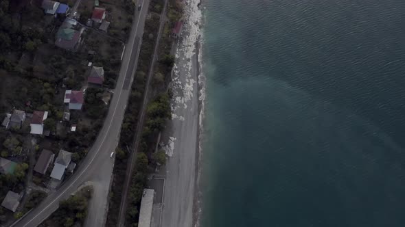 View From Above Nature Landscape with Sea Coast and Asphalt Highway at Early Morning Sunrise