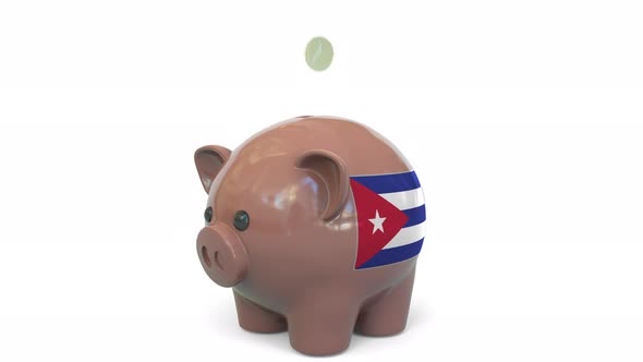 Putting Money Into Piggy Bank with Flag of Cuba