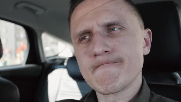 Portrait of a Man Sitting in a Car