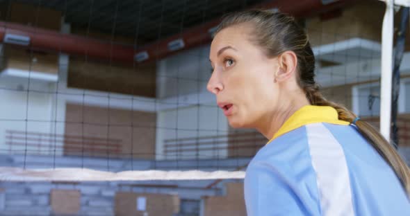 Female volleyball player practising volleyball in the court 4k