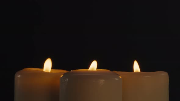 Burning Wax Candles on Black Chroma Key Background