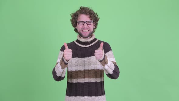 Happy Young Bearded Man Giving Thumbs Up and Looking Excited