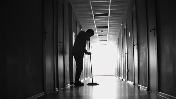 Unrecognizable Cleaner Sweeping Floor