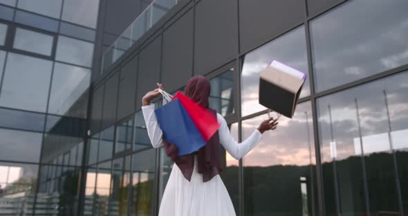 Black Woman Throwing Shopping Bags Into the Air