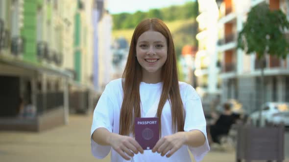 Cheerful Girl Showing International Passport to Camera, Opportunities for Travel