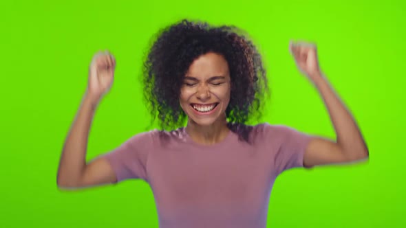 African female raises fingers crossed, makes a desirable wish over chroma key