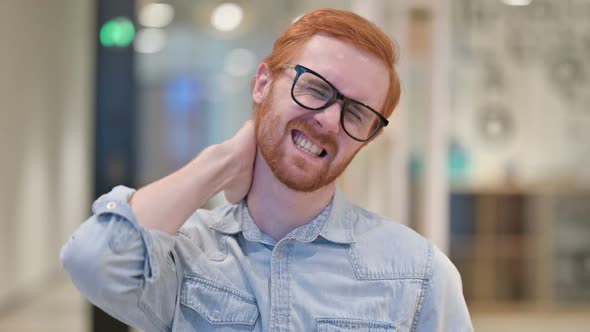 Exhausted Young Redhead Man Having Neck Pain