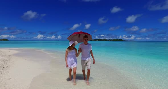 Romantic lady and man on romantic honeymoon enjoy life on beach on white sand background 