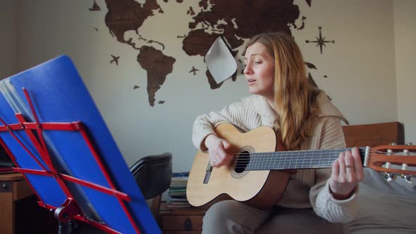 Woman Singing And Playing Guitar