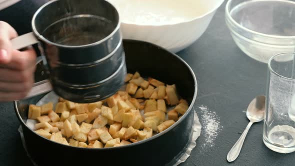 Woman's Hands Spread the Pieces of Apples on a Baking Sheet Covered with Parchment