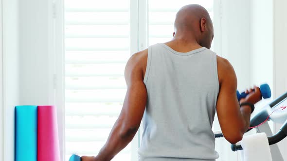 Man exercising with dumbbells 4k