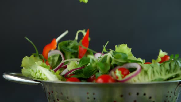 Fresh Salad Flying to Colander in Super Slow Motion